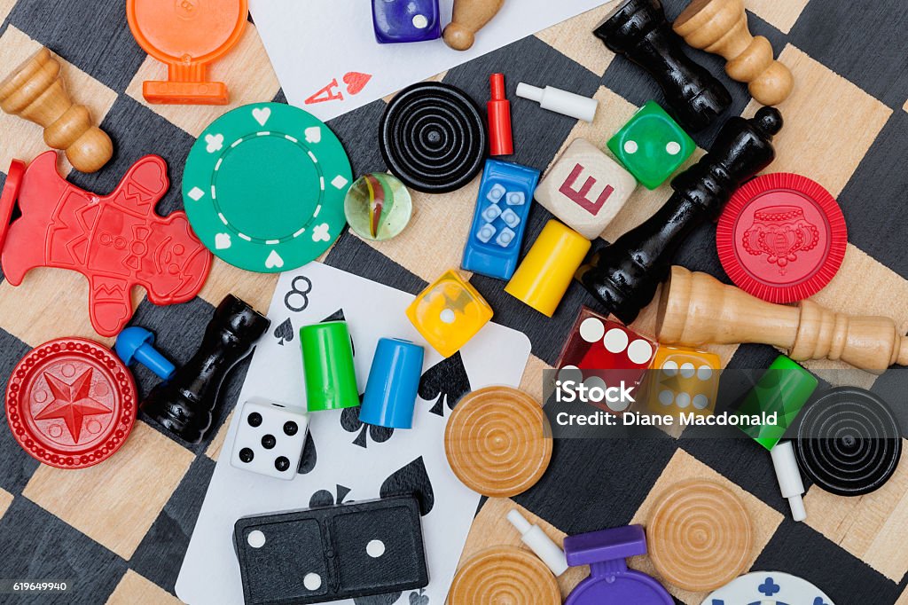 Miscellaneous board game pieces on a chess board